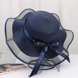 Navy blue sun hat with wide mesh brim and ribbon bow detail for women summer beach travel protection.