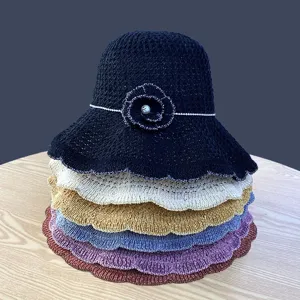 Knitted floral bucket hat for women, elegant summer beach sun hat with hollow design.