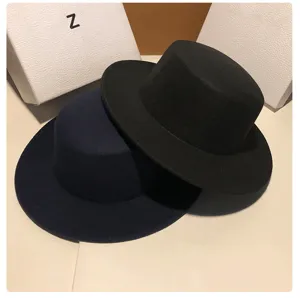 Classic women's flat-top wool felt hat in black and navy blue, elegant winter fashion style.
