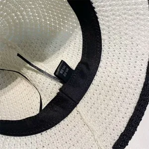 Detail view of women's summer sun hat inner lining showing material label and sweatband.