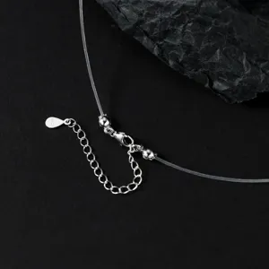 Detail view of the transparent fishing line necklace with S925 silver clasp and extension chain.