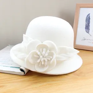 White wool felt cloche hat detail showing elegant floral embellishment for autumn and winter