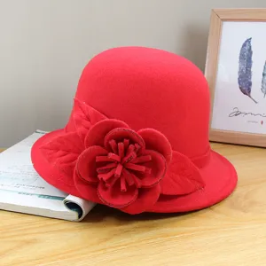 Exquisite red wool felt cloche hat detail showing elegant fabric flower decoration for autumn.