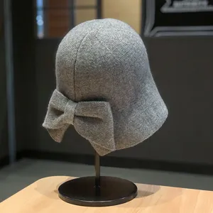 Grey knitted bucket hat with back bow detail, woolen warm basin hat for autumn winter fashion.