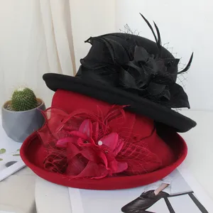 Vue détaillée du chapeau feutre de laine vintage pour femme avec voile en filet et fleur plume.