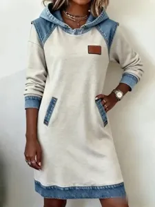 Close-up detail of casual denim spliced hoodie dress, long sleeve, pocket and cuff design.