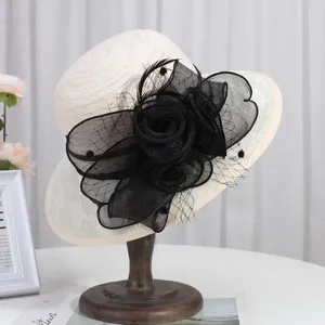 Detail shot of an elegant women sun hat with black mesh flower decoration, perfect for summer.