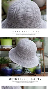 Grey knitted bucket hat detail view, soft woven fabric texture and elegant curved brim design.