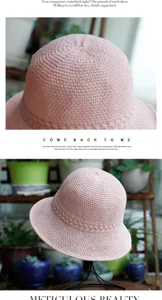 Pink knitted sun bucket hat for women, breathable summer straw hat with braided detail.