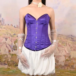 Detailed view of purple satin corset top, featuring front boning and delicate lace-up styling.