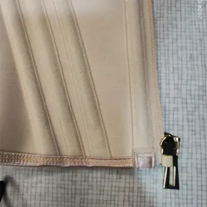 Beige latex waist trainer detail shot, corset waist cincher with zipper and boning.