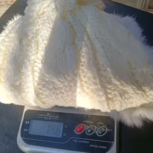 Winter warm knitted bomber hat for women with plush fur ball and fleece lining weight 146g