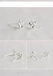 Feine Detailansicht der silbernen Ohrstecker mit filigranem fünfblättrigem Blütendesign.