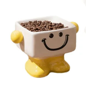Ceramic elevated cat bowl with cute yellow feet and smiley face design for pet food feeding