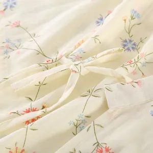 Close-up of floral cotton gauze bathrobe fabric detail, soft texture with cute floral print.