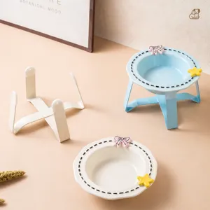 Ceramic pet bowl with elevated stand, cute cat feeding bowl set with bow and star decor.