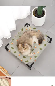 Elevated cat bed with cute avocado print detail, breathable raised pet camp bed for indoor use.