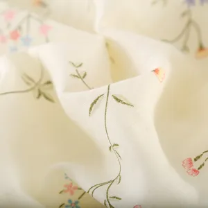Detailed shot of soft cotton gauze fabric with delicate floral print for sleepwear.