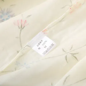 Cotton gauze sleepwear detail showing soft fabric texture and size label for women.