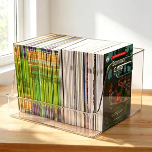 Clear acrylic desktop book storage box detail showing organized children books and magazines.