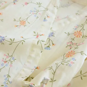 Soft cotton kimono pajama fabric detail, floral print texture close up view for comfort sleepwear.