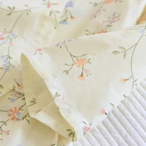 Cotton floral pajama fabric detail, soft yellow cotton texture, comfortable home wear.