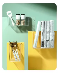 Clear detail view of transparent wall-mounted storage basket for kitchen organization and spice jars.