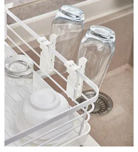 Kitchen dish drying rack detail showing sturdy white wire structure and convenient cup holders.