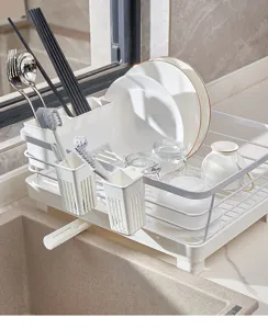 Kitchen dish drying rack detail view, white plastic drainer basket for plates and bowls.