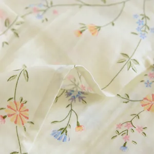 Detail shot of Japanese style cotton pajama fabric with delicate floral embroidery pattern.