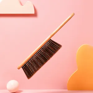 Wooden bed cleaning brush with soft bristles, dust removal broom for home bedding care.
