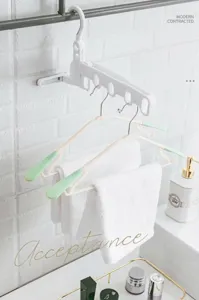 White foldable 5-hole clothes hanger rack hanging towels in a modern bathroom setup