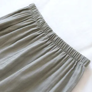 Vista dettagliata della vita elastica su pantaloni da casa grigi, tessuto morbido.