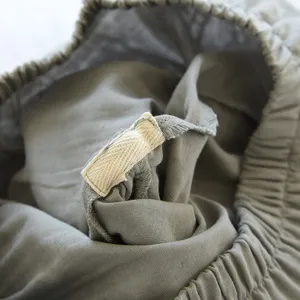 Primo piano dettaglio della cintura e del nastro interno dell'indumento da casa in cotone morbido.