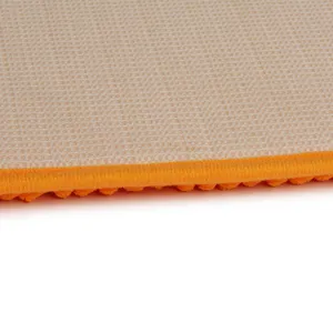 Close-up detail view of chenille pet mat featuring anti-slip backing and vibrant orange trim.