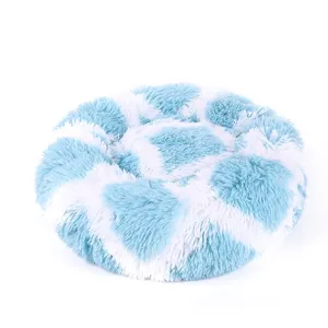 Comfortable round plush pet bed, fluffy soft long fur cat dog sleeping bed detail.