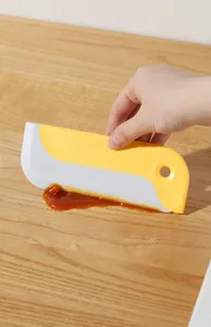 Japanese style cleaning scraper tool, yellow and white silicone spatula for kitchen pots pans.