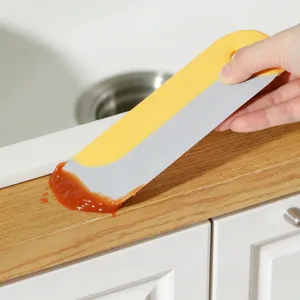 Japanese kitchen cleaning scraper tool, plastic spatula for countertop and pot residue removal.