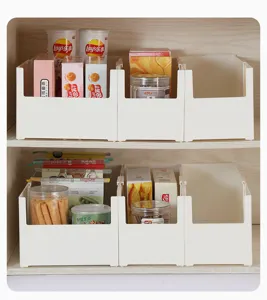 Close-up of six white rectangular plastic storage boxes organized on a wooden pantry shelf