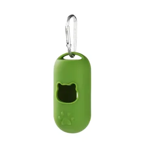 Close up detail of green silicone pet waste bag holder with metal hook and cute paw print design.