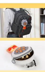 Portable dog poop bag dispenser and pet treat pouch with cute paw print design for outdoor walks.