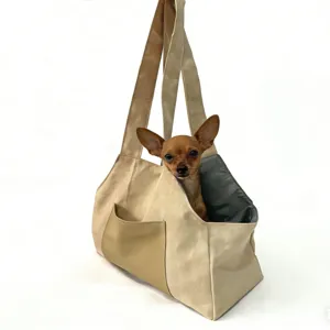 Breathable pet carrier bag for small dogs and cats, portable single-shoulder design with pocket.