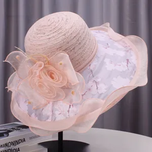 Detailed view of an elegant pink sun hat with delicate lace and floral decorations for women.