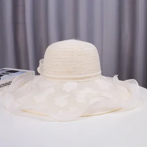 Elegant white lace sun hat detail, wide brim floral pattern design for summer beach wear.