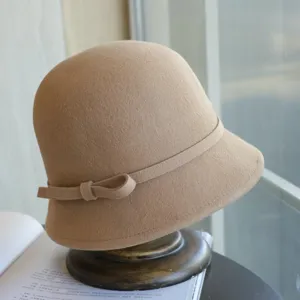 Exquisite beige wool felt cloche hat detail, featuring a side bow and retro Hepburn style.
