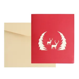 3D pop-up Christmas greeting card with hollow deer and tree design, includes beige envelope.