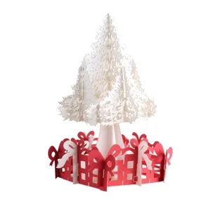 Detailed close-up of 3D pop-up Christmas tree greeting card with hollow paper gift base.