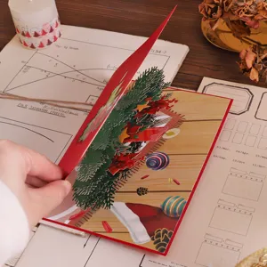 Detail view of 3D pop-up Christmas tree greeting card with holiday paper carving design.