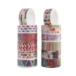 Detailed view of artistic washi tape rolls with abstract patterns and gold foil for crafts.