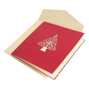 Detailed shot of a red 3D pop-up Christmas tree greeting card with a cream envelope.